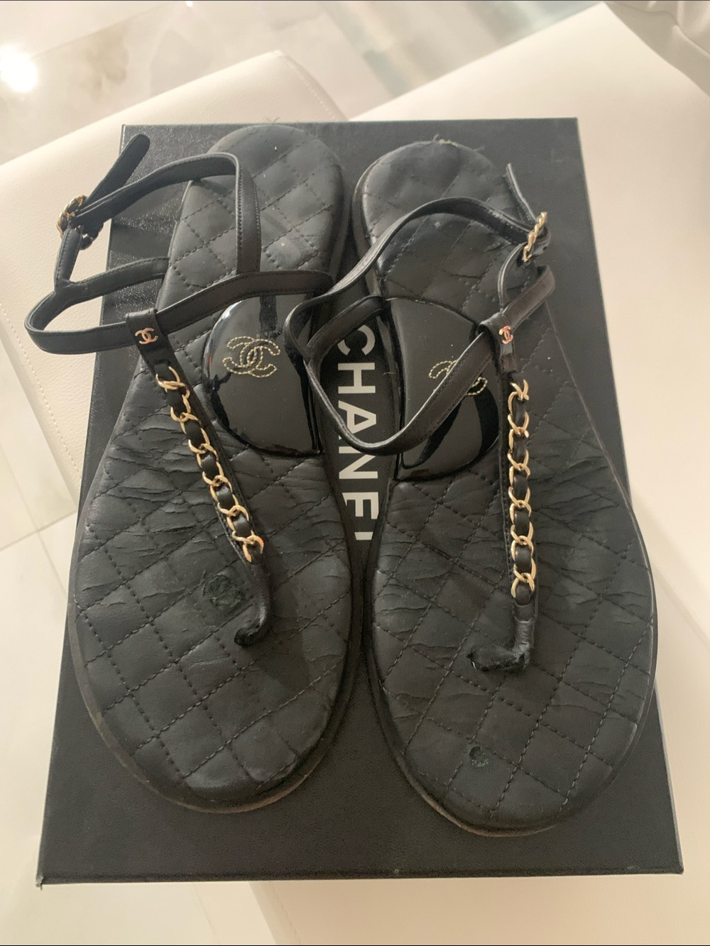 CHANEL Black Quilted Leather T-Strap Sandals with Gold Chain Detail